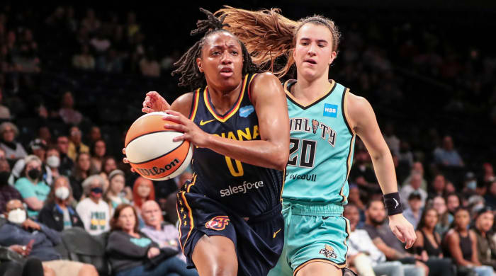 Fever guard Kelsey Mitchell drives past Liberty guard Sabrina Ionescu.